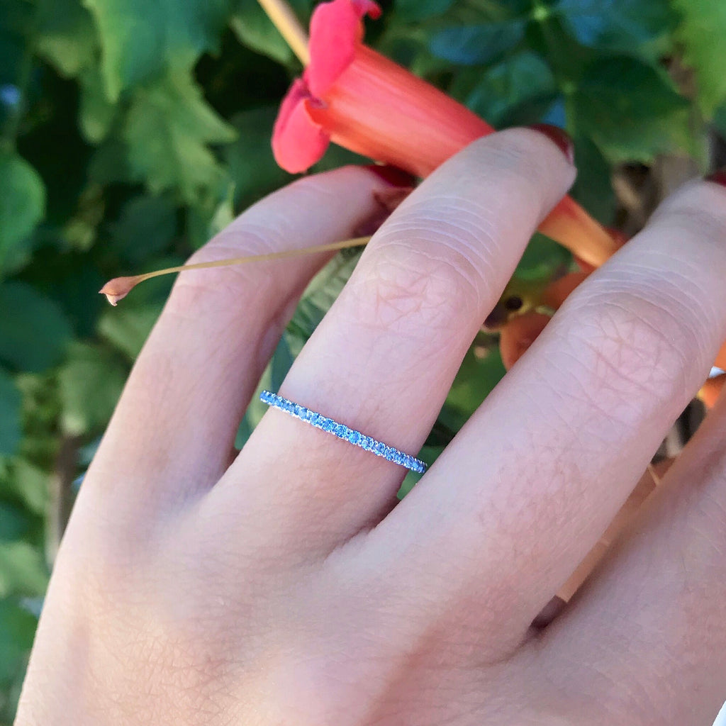 18K White Gold Sky Blue Topaz Eternity Band 1.4mm Zina Tahiri Inc